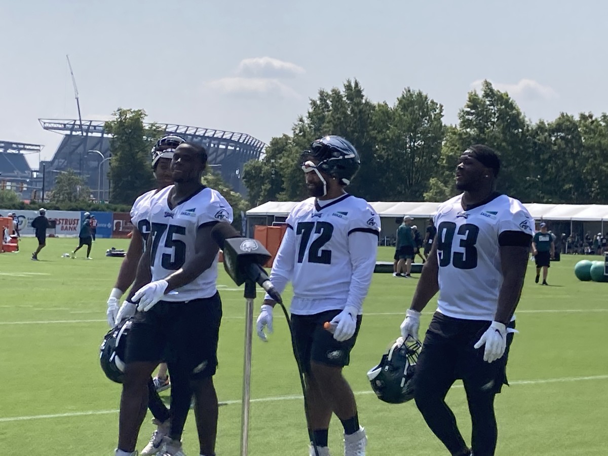 Eagles rookie defensive lineman Tarron Jackson (75), Marlon Tuipulotu, and Milton Williams leave the pratice field on July 27, 2021